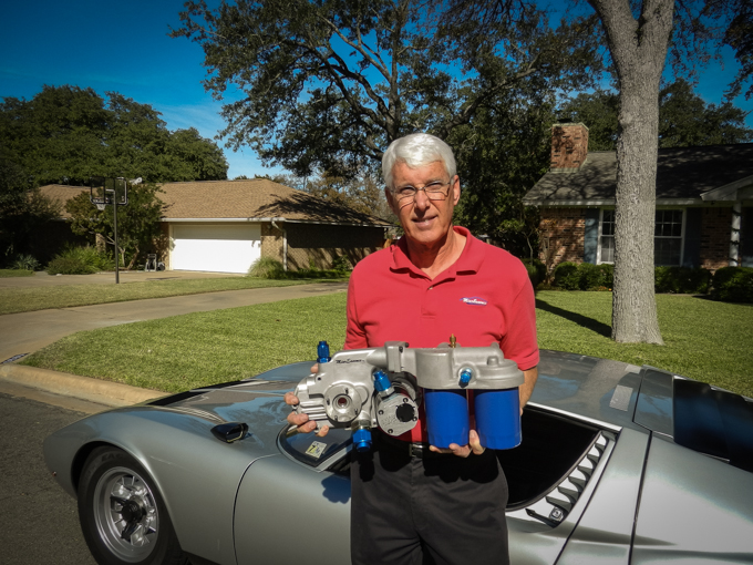 Scott in front of the Lambo, holding one of the finished  components of his dry sump lubrication system.